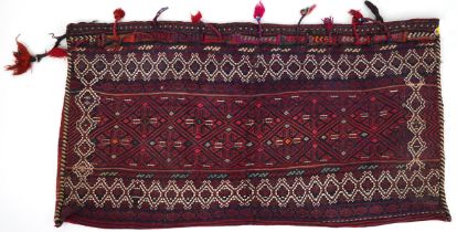 Rectangular Afghan red ground saddle bag having an allover repeat design, 150cm x 80cm