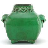 Chinese porcelain green glazed four footed vase with animalia ring turned handles and ruyi head