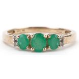 9ct gold emerald and diamond ring set with three emeralds and four diamonds, size N, 1.6g