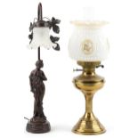 Art Nouveau style bronzed figural table lamp with frilled glass shade and a brass oil lamp with