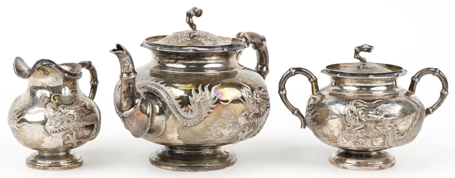 Chinese export silver and three piece tea service having simulated bamboo handles embossed with