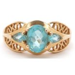 Chinese 14K gold blue topaz three stone ring with pierced shoulders, the central topaz approximately