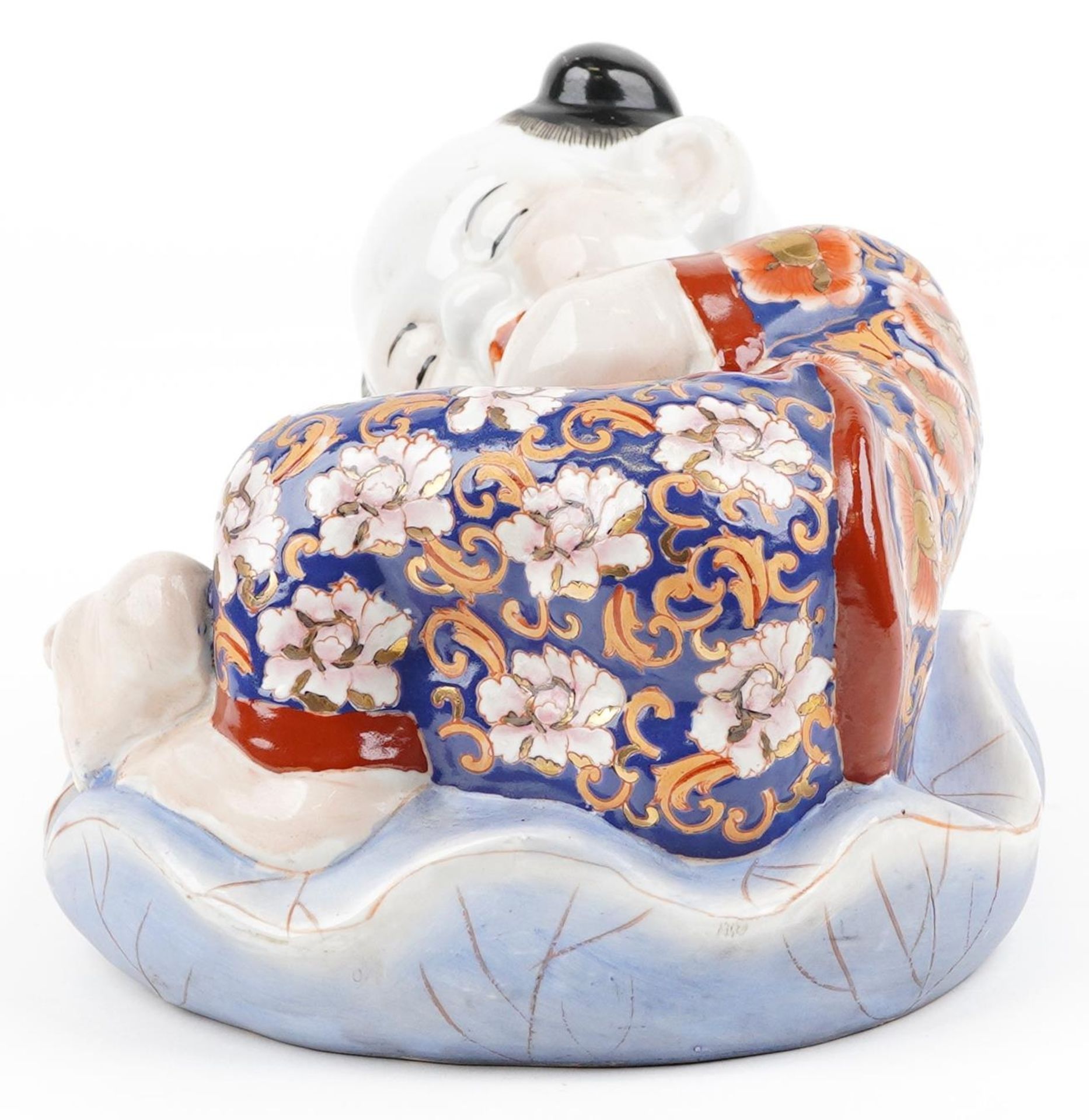 Chinese porcelain figure of a sleeping boy hand painted in the Imari palette, 24cm wide - Image 3 of 9