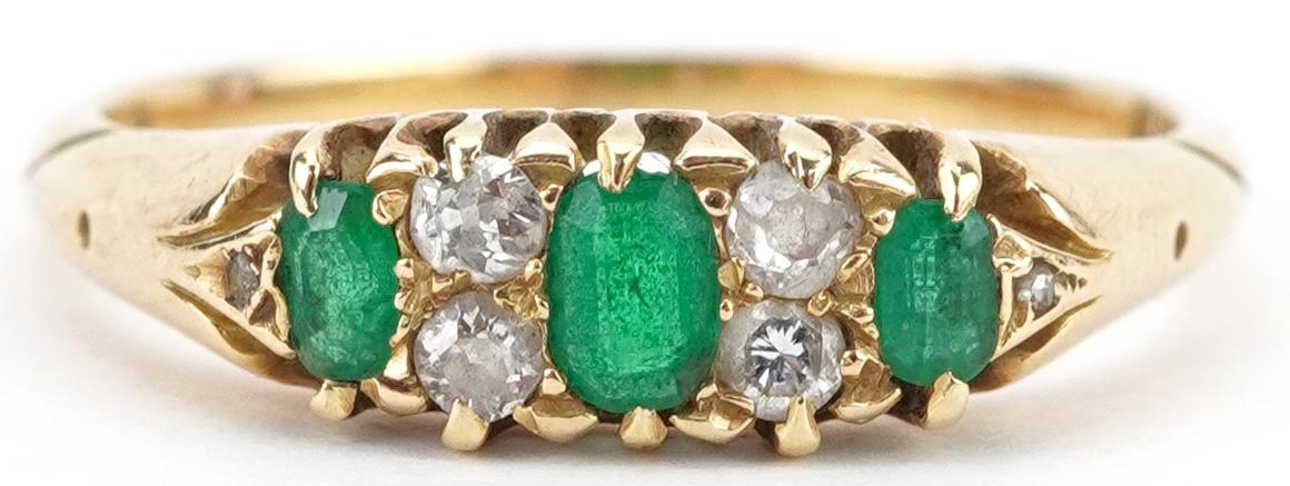 18ct gold emerald and diamond seven stone ring, the largest emerald approximately 3.70mm x 2.40mm