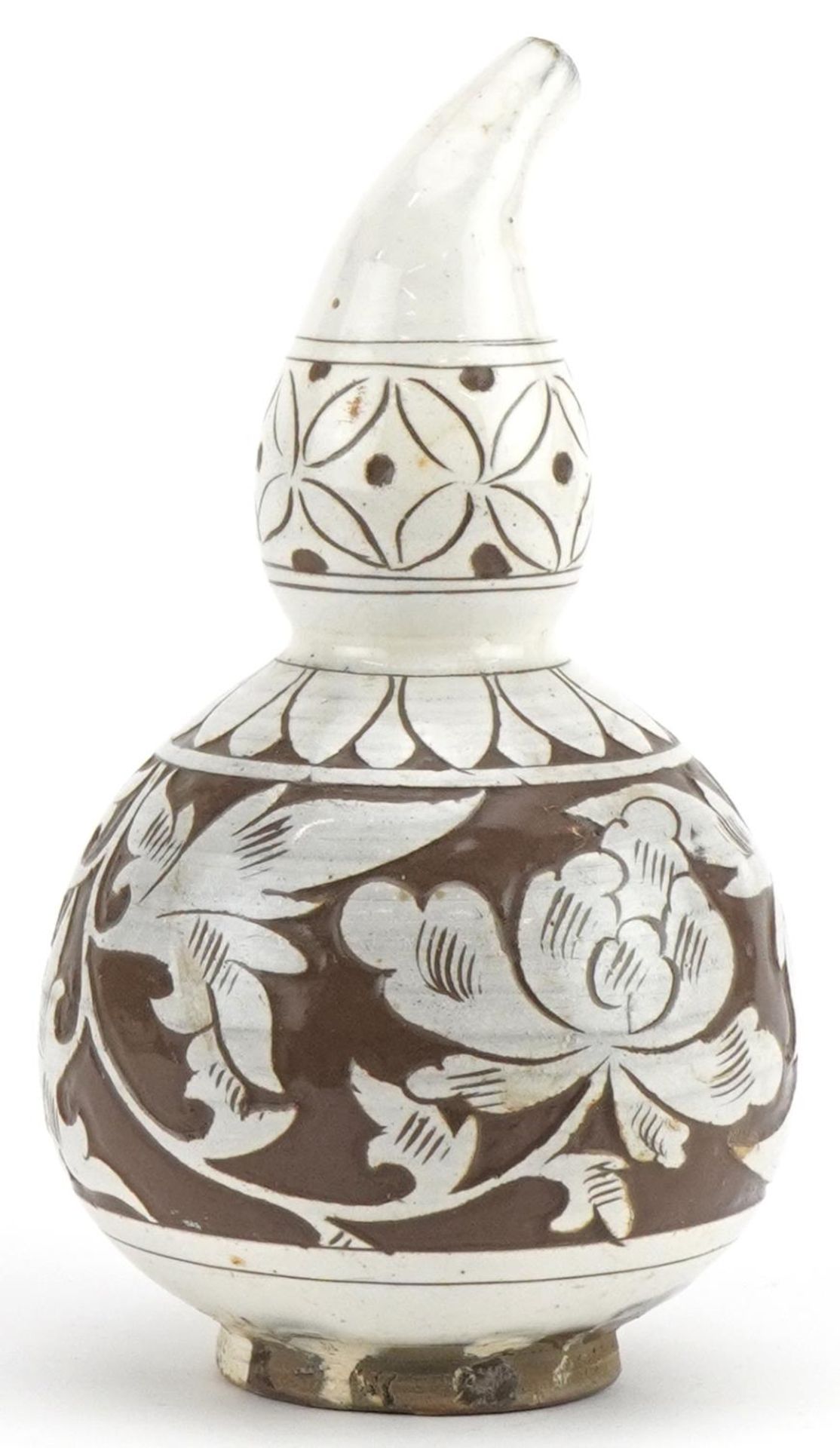 Chinese porcelain gourd vase having a white glaze incised with flowers, 16.5cm high