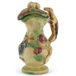 19th century Majolica lidded jug with handle in the form of a Greyhound, decorated in relief with