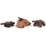 Three 19th/20th century military interest patinated bronze and hardwood table cannons, the largest