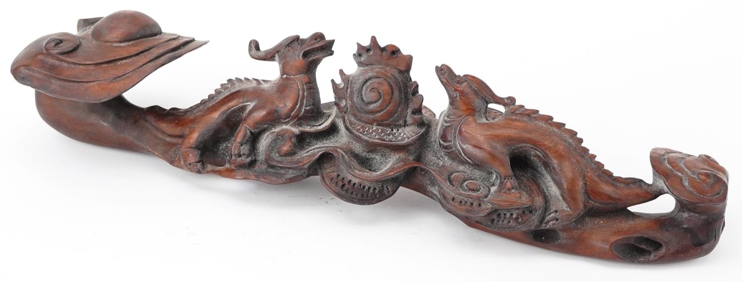 Chinese hardwood ruyi sceptre carved with two dragons chasing the flaming pearl, 43cm wide