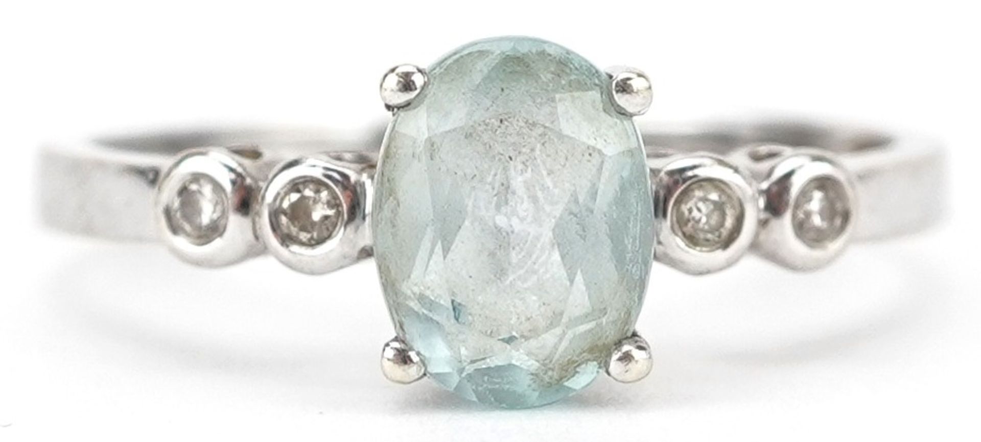 9ct white gold blue topaz ring with diamond set shoulders, the topaz approximately 8.0mm x 6.0mm x