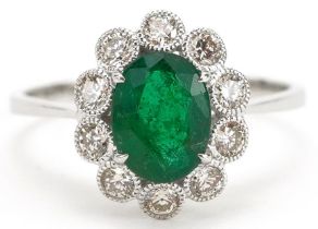 18ct white gold emerald and diamond flower head ring, the emerald approximately 1.42 carat, total