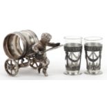 Silver plated napkin holder in the form of a boy pulling a cart and a pair of pewter and glass