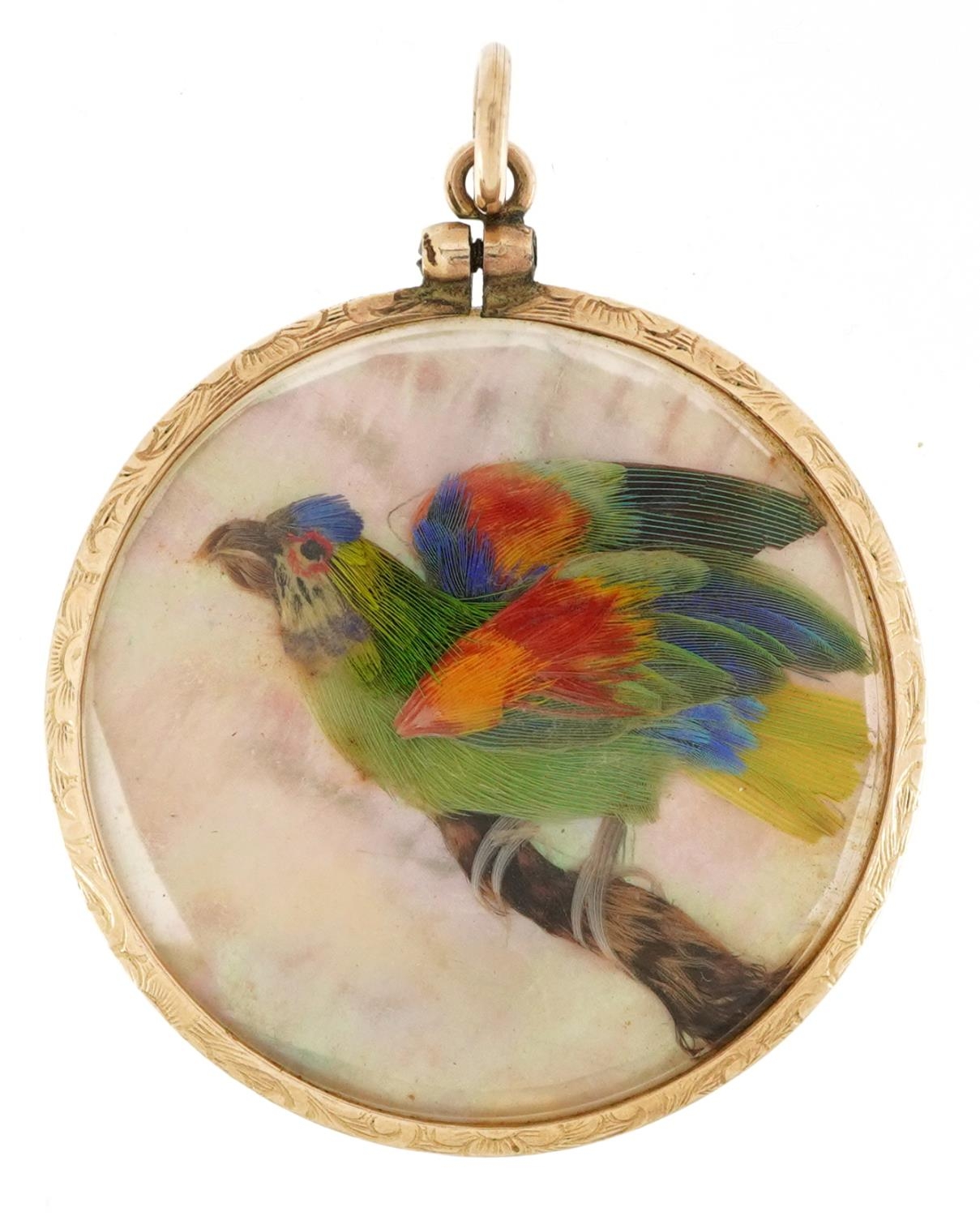 Unmarked gold mother of pearl collage locket decorated in feathers with two birds, 3.2cm in