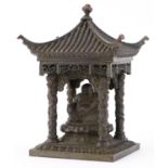 Chinese patinated bronze study of Buddha seated in a pagoda, 15cm high