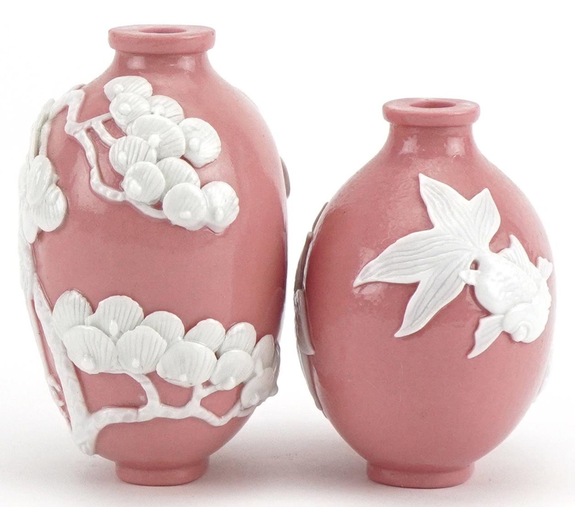 Two Chinese porcelain pink ground snuff bottles decorated in relief with fish and a crane, the - Bild 2 aus 8