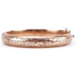 9ct gold floral engraved hinged bangle, 6.5cm wide, 13.4g