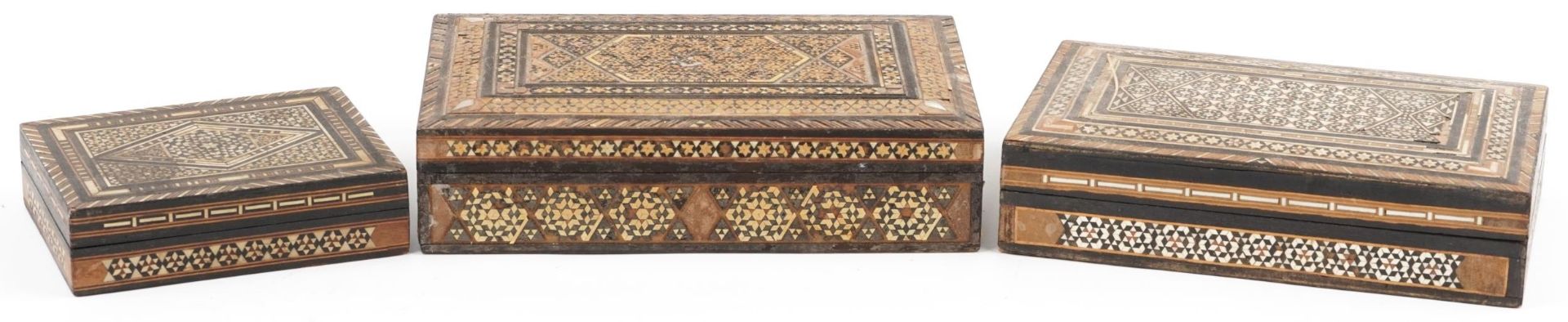 Three Syrian Moorish style rectangular inlaid wooden boxes, the largest 22cm wide