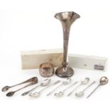 Silver objects comprising seven teaspoons, napkin ring, sugar tongs and bud vase, the largest 19.5cm