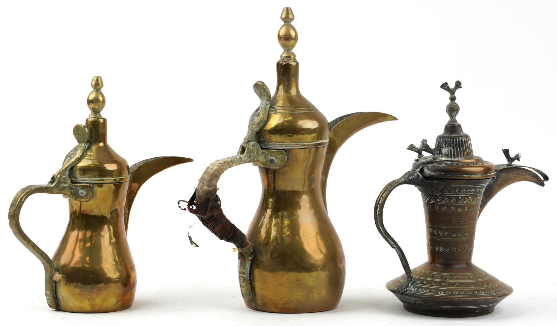 Three Omani brass dallah coffee pots including an example with bird knops, the two others with - Image 2 of 3