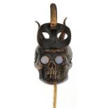 Antique yellow and white metal stickpin in the form of the devil with hinged mask and opal eyes, 8cm