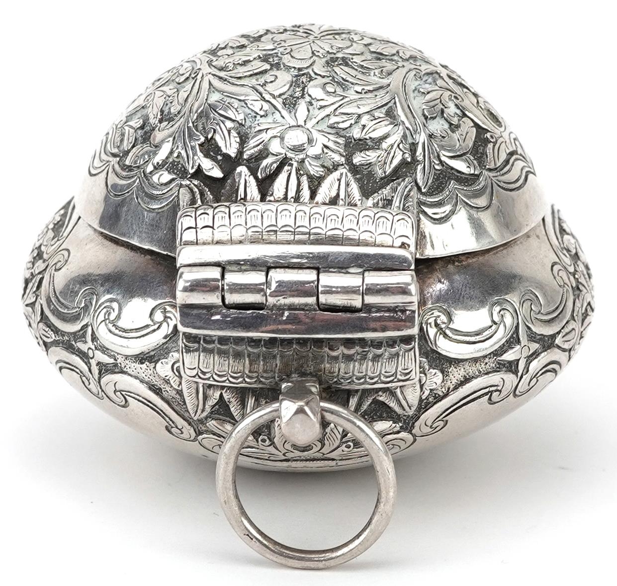 Tibetan unmarked silver bun shaped box with hinged lid profusely embossed with flowers and - Image 4 of 5