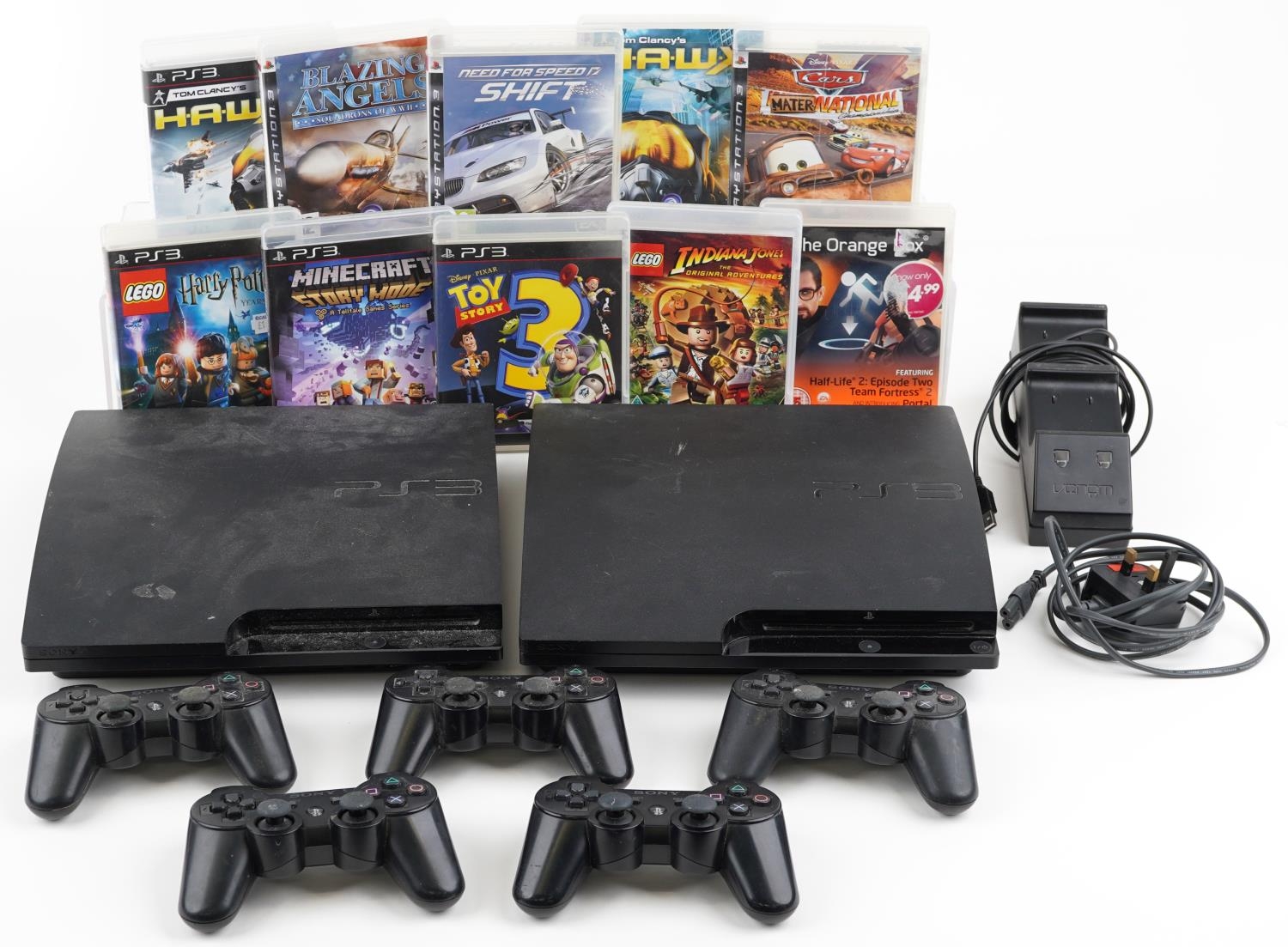 Two Sony PlayStation 3 games consoles with five controllers, docking station and games including Tom