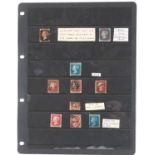 Victorian British stamps arranged on a sheet including Penny Black, Two Penny Blues and Penny Reds