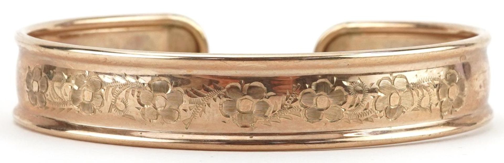 9ct gold floral engraved cuff bangle, 6.5cm wide, 9.0g