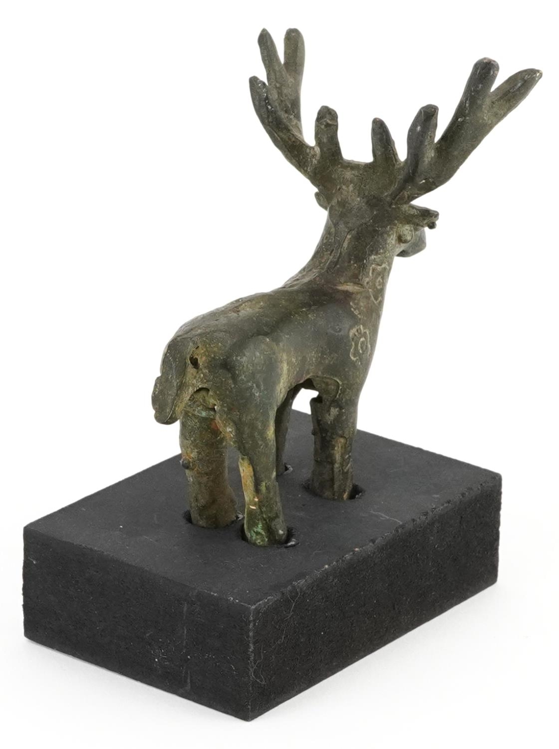 Middle Eastern Luristan type bronze of a deer raised on a rectangular black painted wooden base, - Image 2 of 3