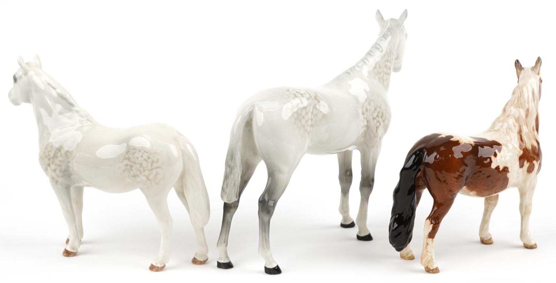 Three Beswick collectable horses comprising pinto skewbald pony, two dapple grey examples, one - Image 2 of 4