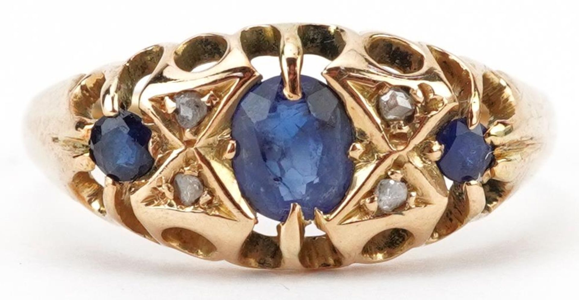 Antique 18ct gold sapphire and diamond seven stone ring with pierced ornate setting, the largest