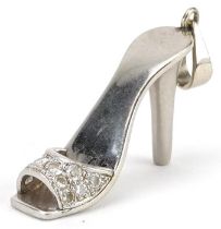 Unmarked white gold diamond charm in the form of a high heeled shoe, tests as 18ct gold, 3.5cm in
