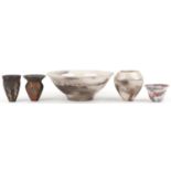 Contemporary raku glazed studio pottery including a centre bowl and two vases having an abstract