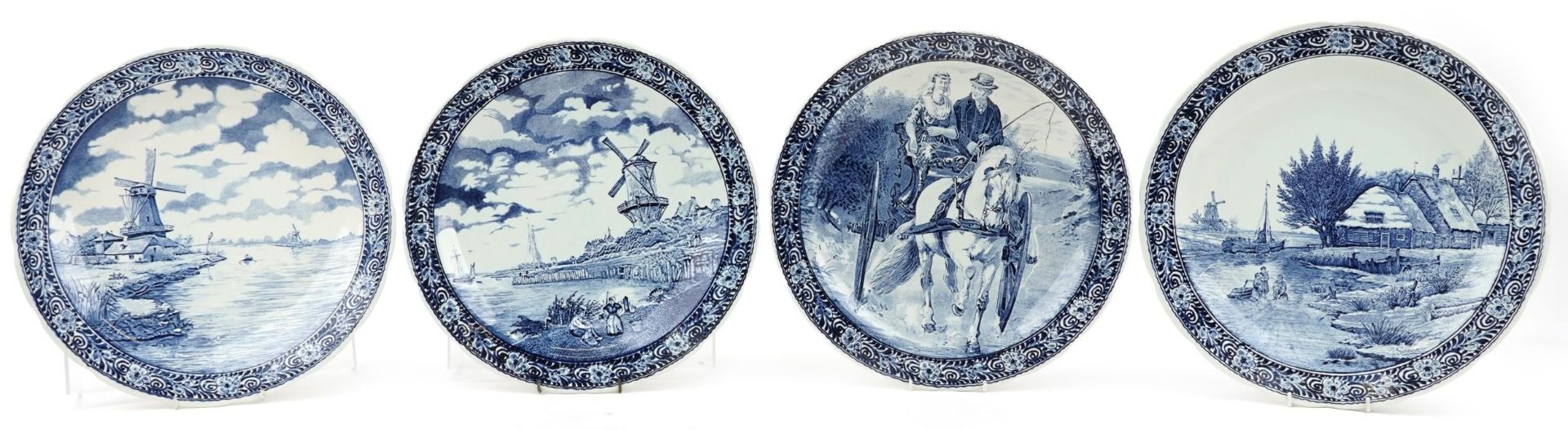 Boch, four Dutch Delft blue and white chargers including examples decorated after T Sonneville and