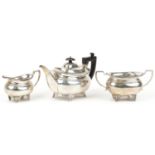 Daniel & John Wellby, Victorian silver three piece tea service, the teapot with wooden handle and