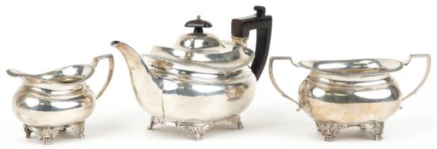 Daniel & John Wellby, Victorian silver three piece tea service, the teapot with wooden handle and