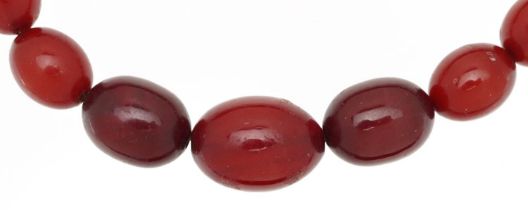 Cherry amber coloured bead necklace, the largest bead approximately 22mm x 16mm, overall 60cm in