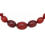 Cherry amber coloured bead necklace, the largest bead approximately 22mm x 16mm, overall 60cm in