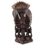 Large Burmese hardwood carving of a deity and mythical animals, 56cm high