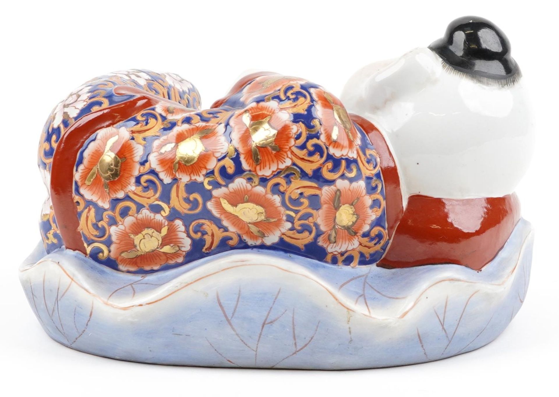 Chinese porcelain figure of a sleeping boy hand painted in the Imari palette, 24cm wide - Image 4 of 9