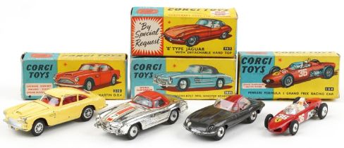 Four vintage Corgi Toys diecast vehicles with boxes comprising Aston Martin DB4 218, E Type Jaguar