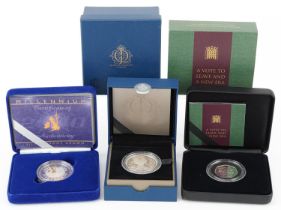 Three silver proof coins by The Royal Mint with fitted cases, comprising Millennium silver proof