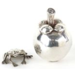 Silver model of a seated frog and a silver filled model of a pome fruit, the largest 7.5cm high,