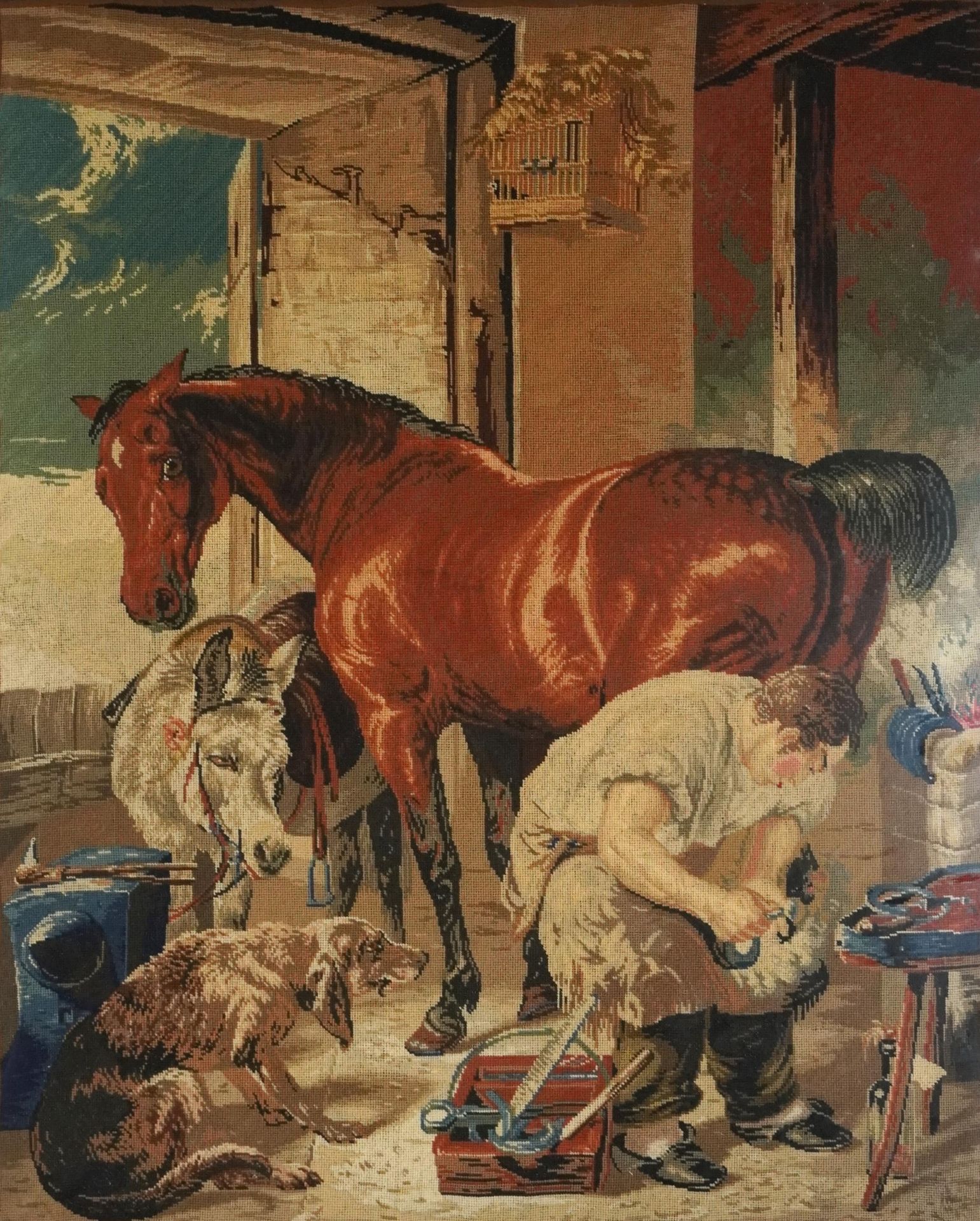 Farrier shoeing a horse with donkey and gundog, 19th century needlework tapestry, framed and glazed,