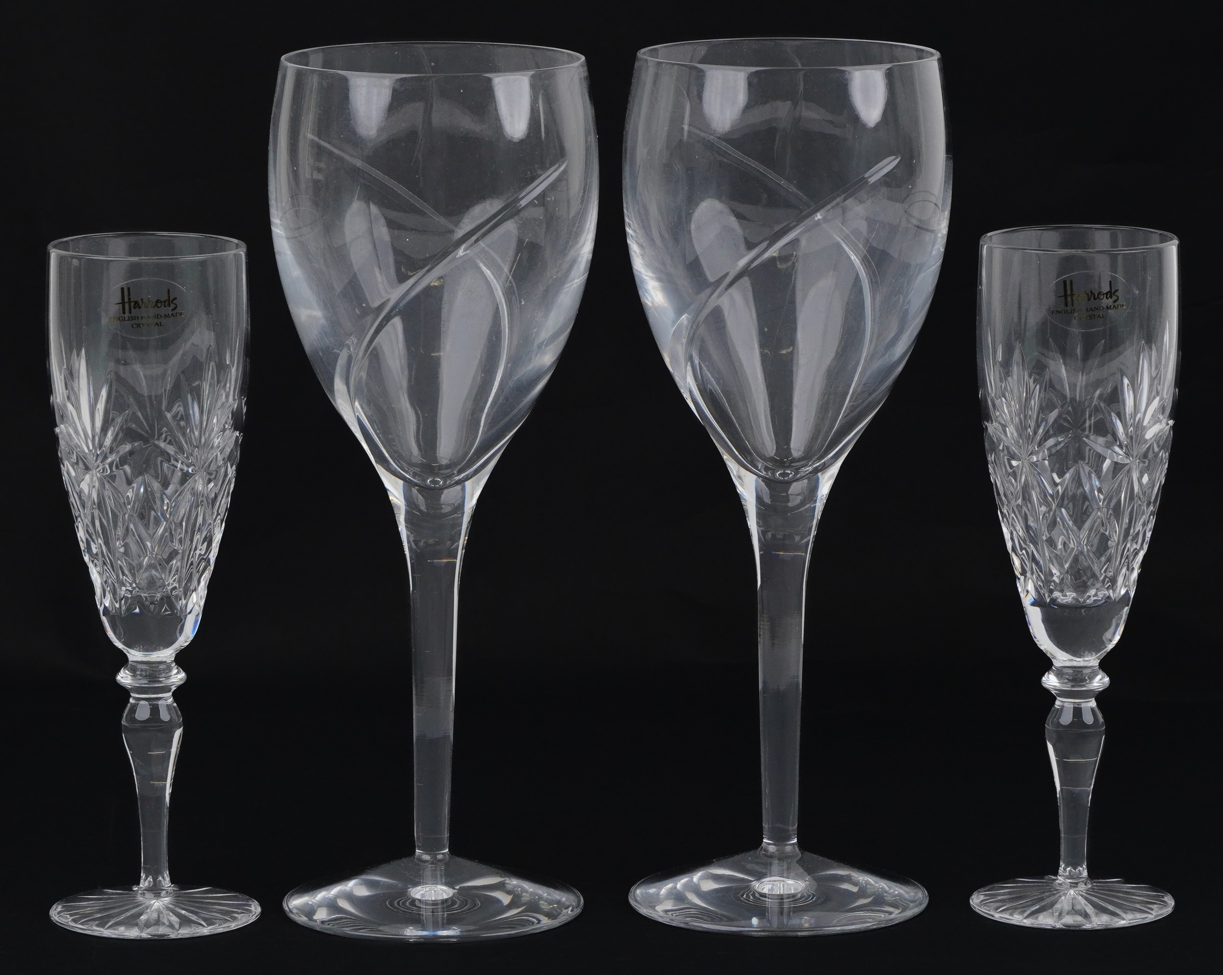 Two pairs of glasses comprising Waterford and Harrods, the largest each 24cm high