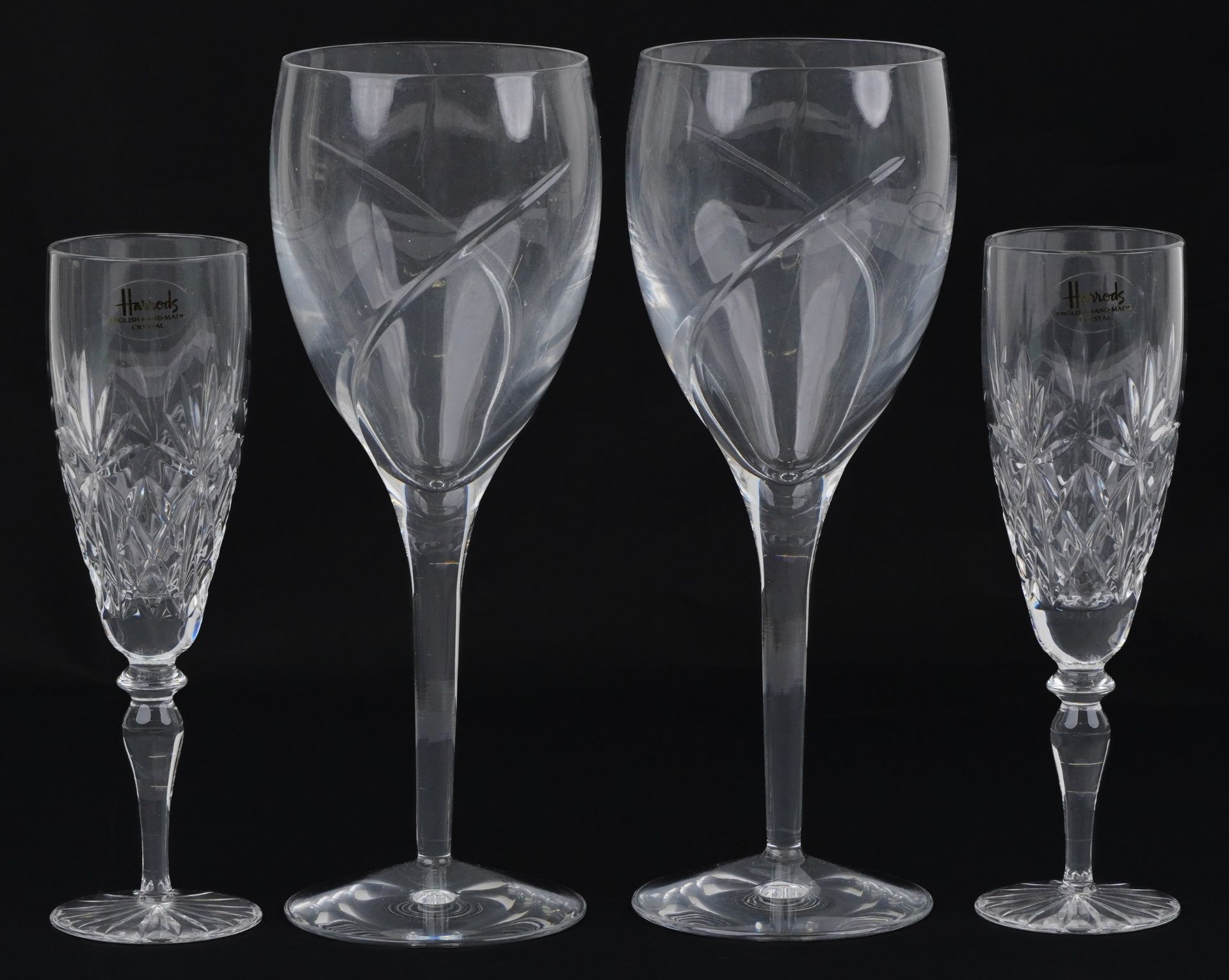Two pairs of glasses comprising Waterford and Harrods, the largest each 24cm high