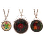 Three silver mounted enamel coin pendants on silver necklaces comprising two shillings, one shilling