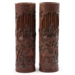 Pair of Chinese cylindrical bamboo vases carved with figures amongst trees and pavilions, each