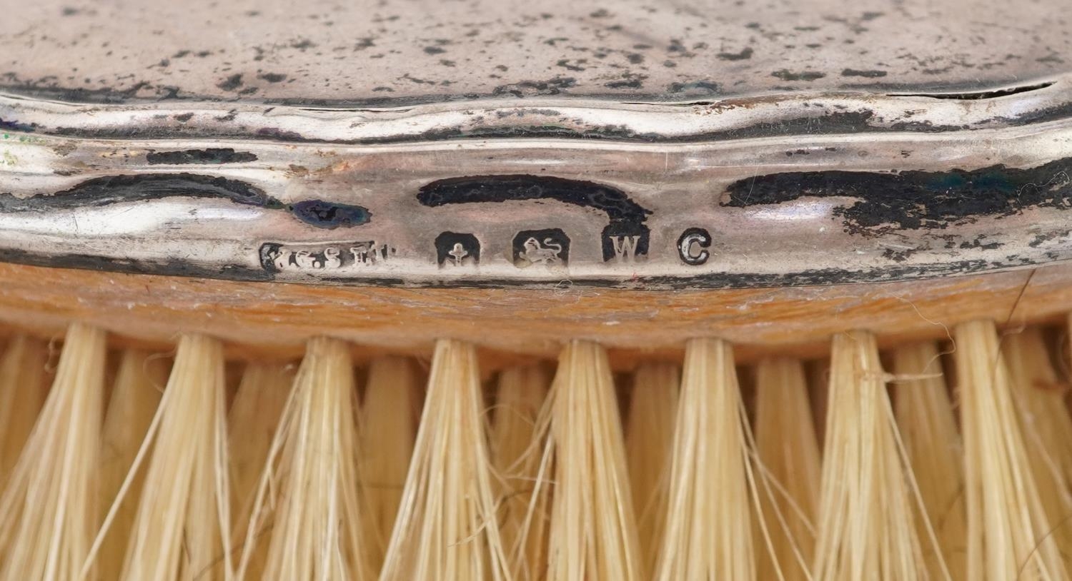 Two Edwardian silver backed clothes brushes and a hand mirror, the largest 27cm in length - Image 3 of 4