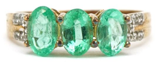9ct gold emerald three stone ring with white spinel set shoulders, size N, 2.0g