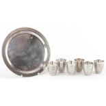 Set of six Modernist chrome shot glasses on circular tray, largest 16cm in diameter